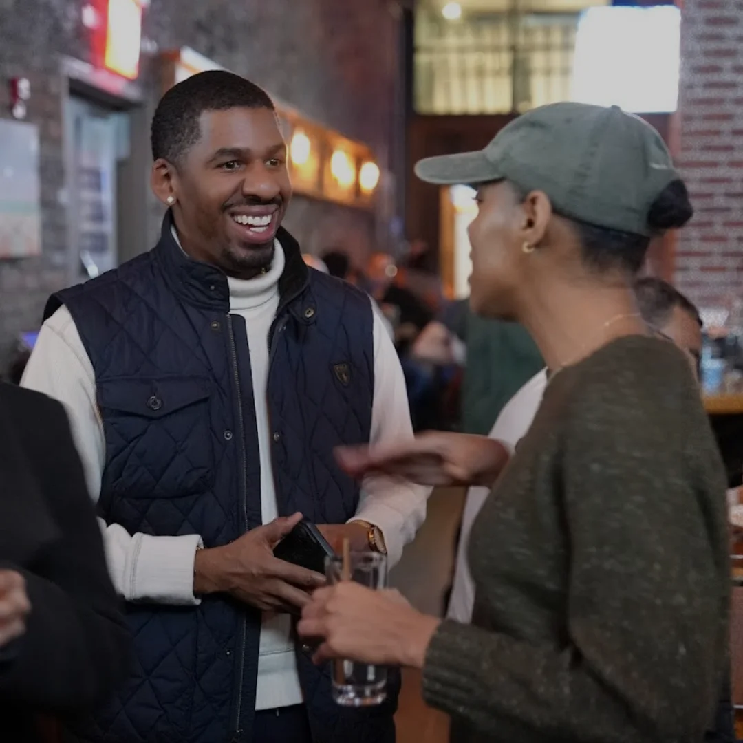 Two attendees connecting at an Arena community event