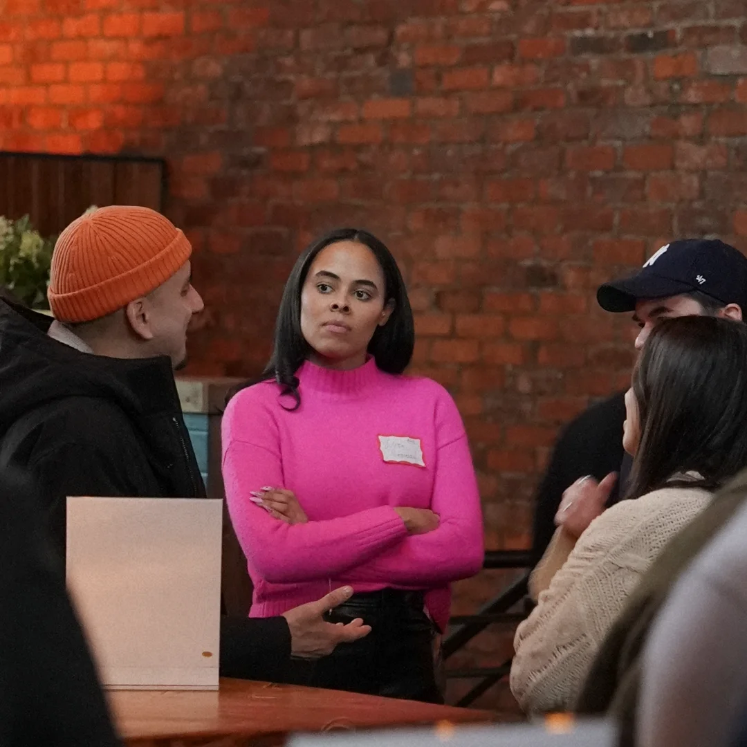 A speaker in conversation at an Arena community event